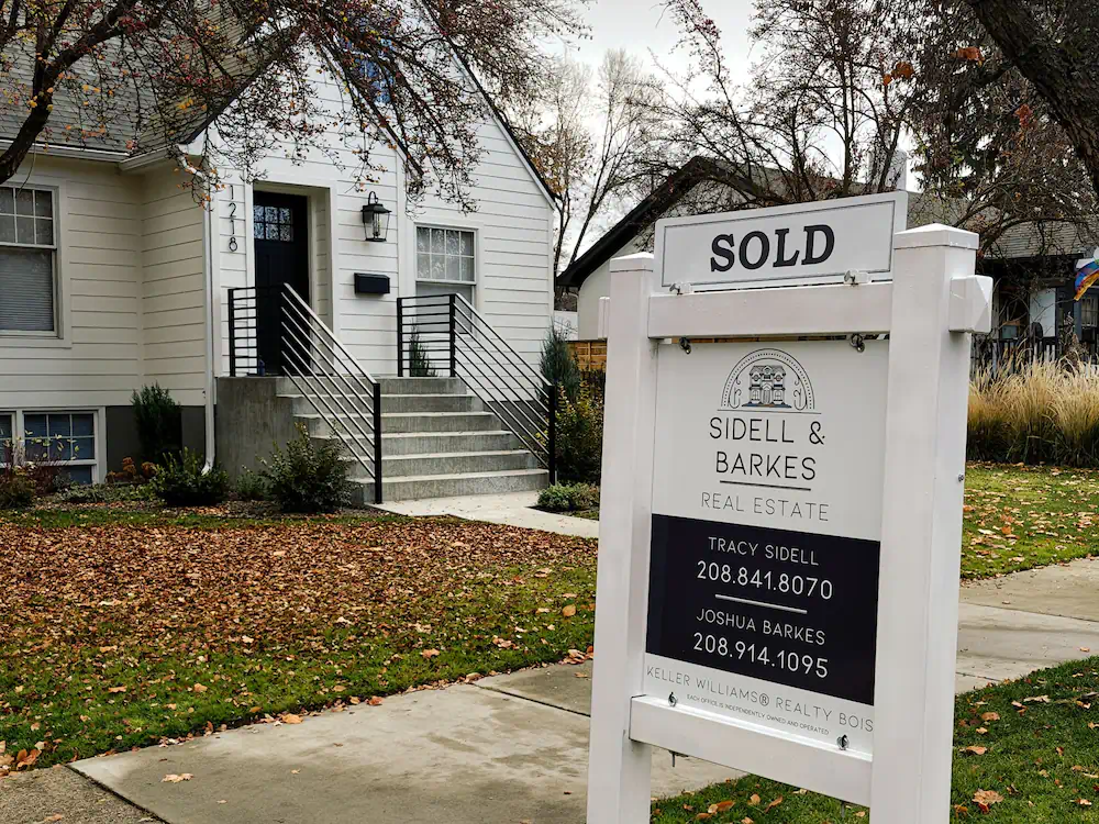 A sold sign in the yard of a striking and elegant North End cottage, that had a pool.