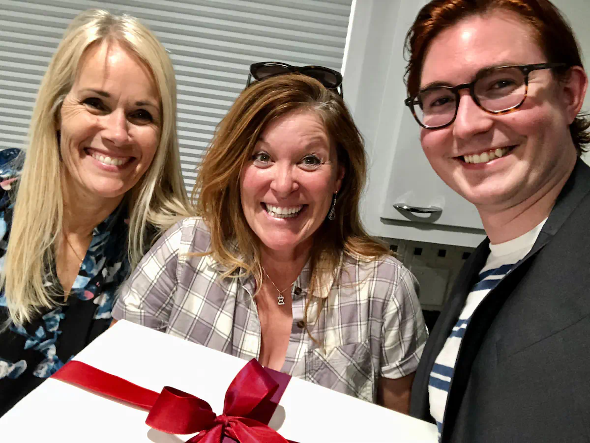 Delighted buyer celebrating in the kitchen of her new home after relocating to the Boise Bench.