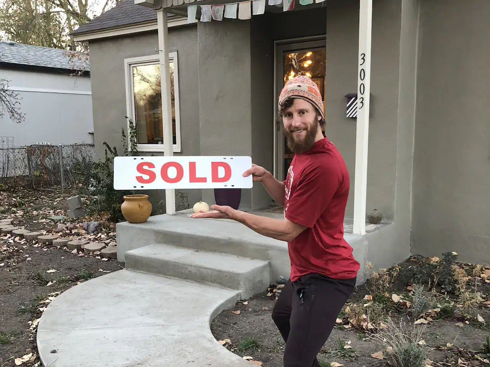 Single Buyer standing in front of their new-to-them North End cottage.